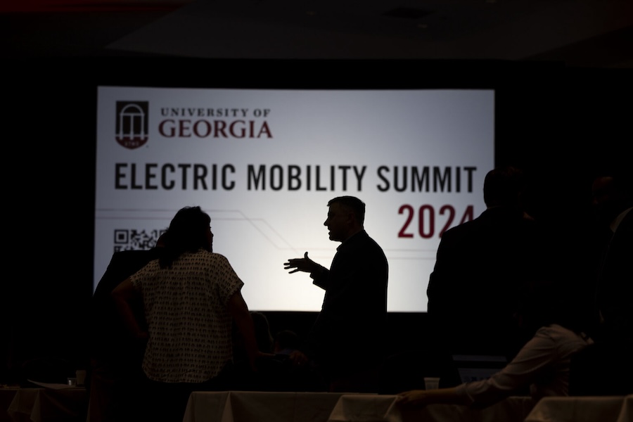 Attendees socialize with each other before the start of the 2024 Electric Mobility Summit at the Classic Center. (Photo by Andrew Davis Tucker/UGA)